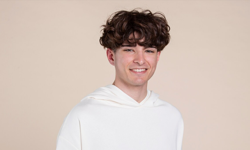 a boy with long hair and white tshirt